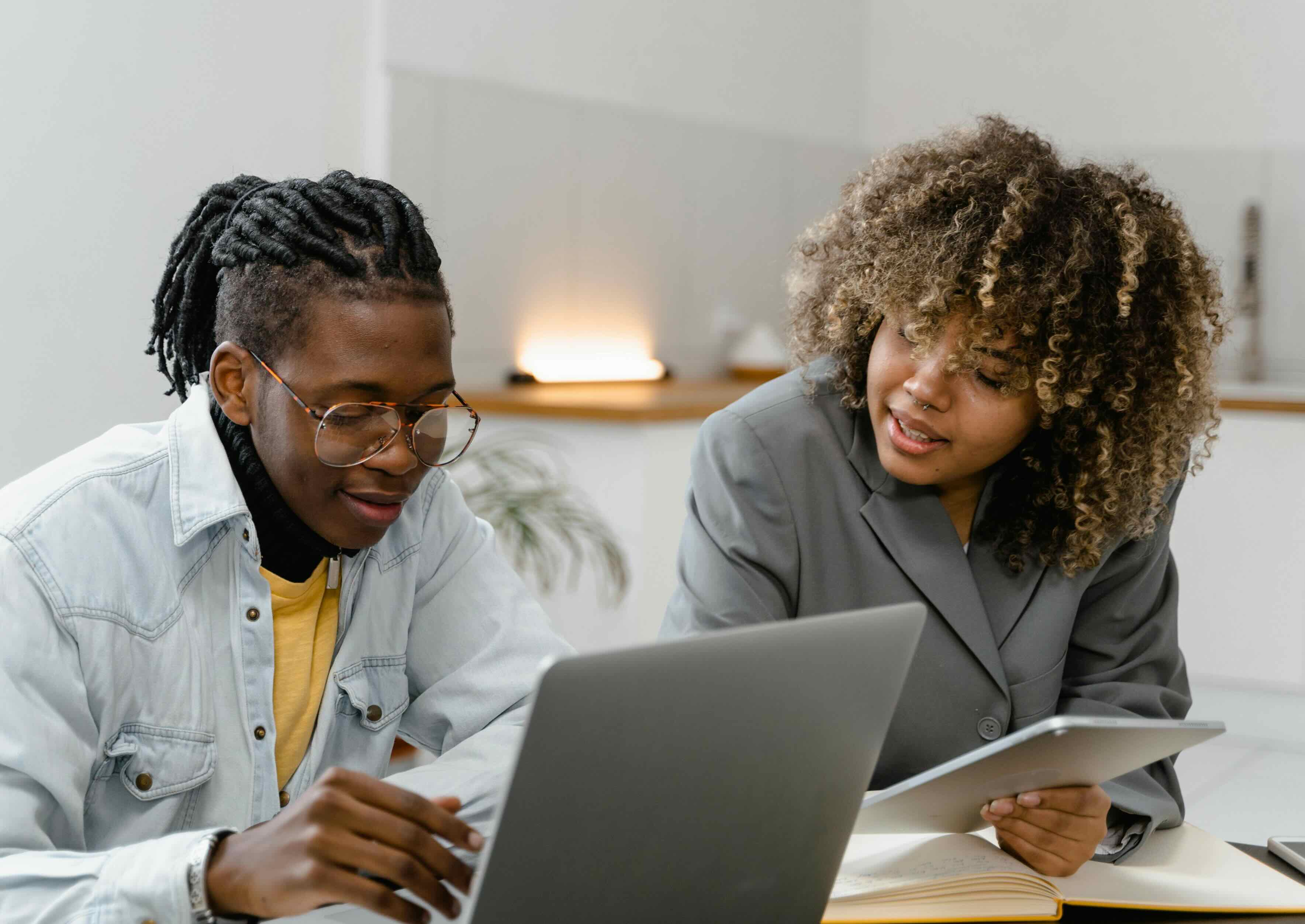 Woman using a laptop while sitting on the couch.