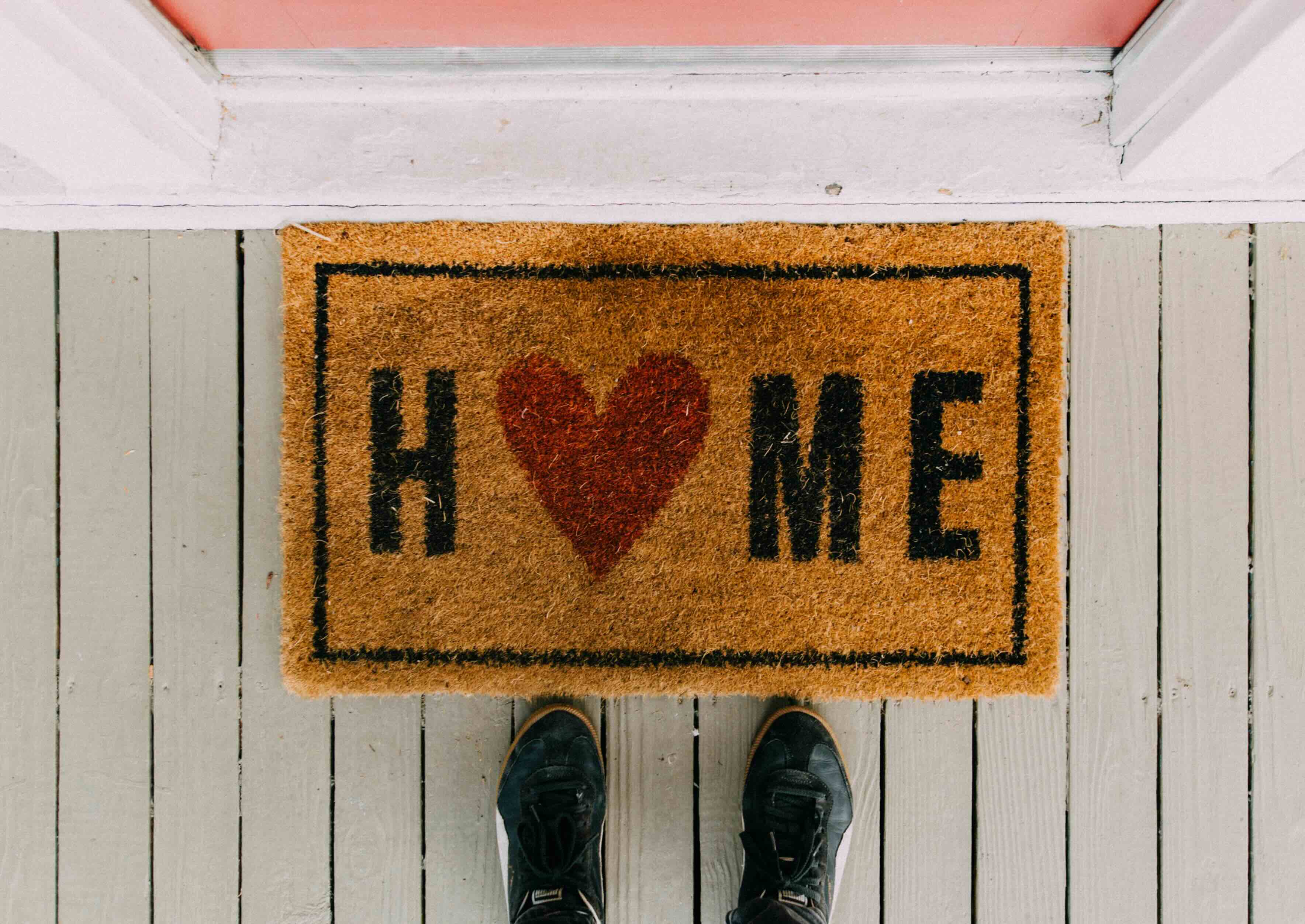 Woman using a laptop while sitting on the couch.